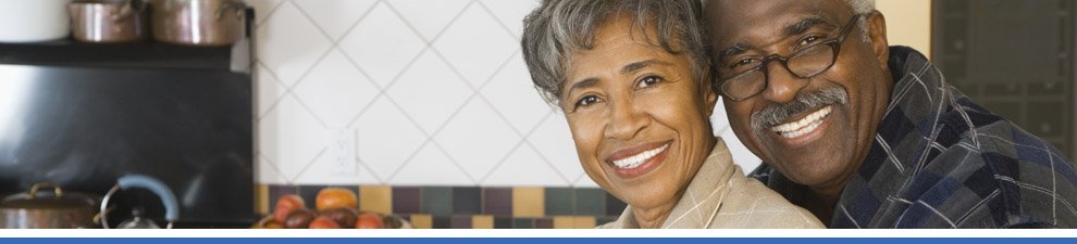 Older couple smiling in kitchen