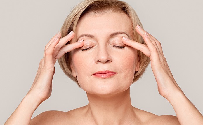 Woman rubbing eyelid